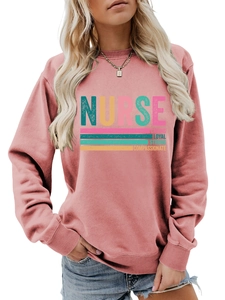 Detail of nurse slogan print on soft rose red crewneck sweatshirt with ribbed cuffs