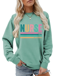 Close-up of nurse hoodie showing mint green fabric texture and colorful text details