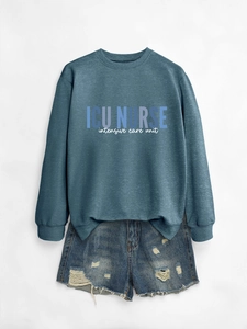 Detailed flat lay of ICU NURSE printed sweatshirt with ripped denim shorts