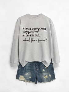 Flat lay of gray long sleeve sweatshirt with text paired with distressed denim shorts