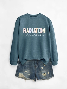 Detail of Radiation Therapist navy crewneck sweatshirt with colorful printed text