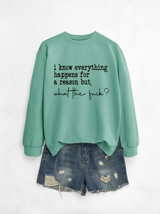Detail of mint green sweatshirt with print and distressed denim shorts on white background