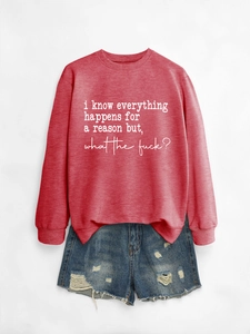 Detail of red crewneck sweatshirt with white quote print and distressed denim shorts