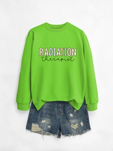Detail of lime green crewneck sweatshirt with Radiation Therapist print and denim shorts