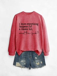 Detail of red crewneck sweatshirt with black slogan and distressed denim shorts