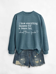 Flat lay of teal crewneck sweatshirt with slogan and distressed denim shorts set