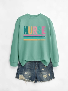 Detail of mint green nurse sweatshirt paired with distressed blue denim shorts