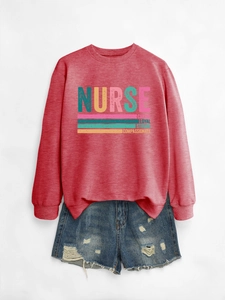 Flat lay of red nurse sweatshirt with blue distressed denim shorts on grey background