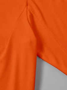 Detail of flat seam stitching and knit texture on long sleeve bright orange t-shirt