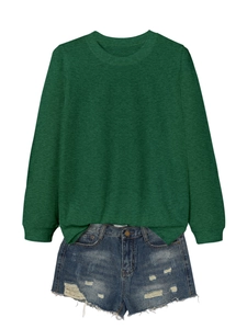 Detailed view of dark green long sleeve crewneck sweatshirt and distressed denim shorts