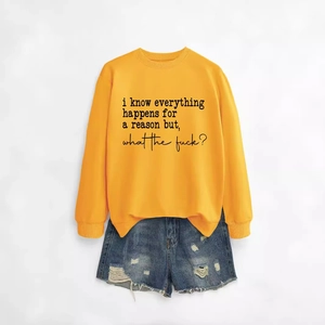 Yellow crewneck sweatshirt with black text print paired with distressed denim shorts