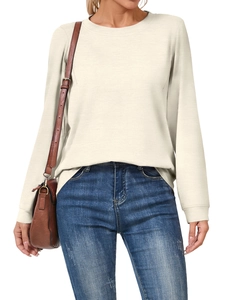 Detail of cream long sleeve crewneck top showing knit texture and ribbed collar on model