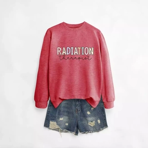 Women's crewneck radiation therapist sweatshirt paired with distressed denim shorts