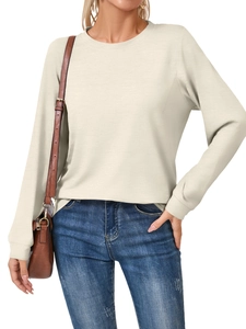 Detail of soft beige crew neck sweatshirt paired with jeans for a casual lifestyle look