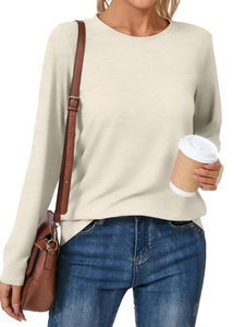 Close-up of casual beige long sleeve crewneck top styled with a leather shoulder bag