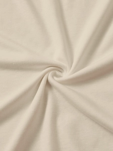 Close-up of soft cream knit fabric texture showing high-quality stitching and material