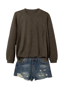 Flat lay of a long sleeve crewneck sweatshirt and distressed denim shorts with raw hem