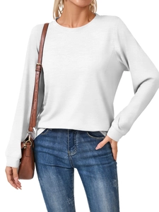 Detail of the white long sleeve shirt showing the ribbed cuffs and soft cotton texture