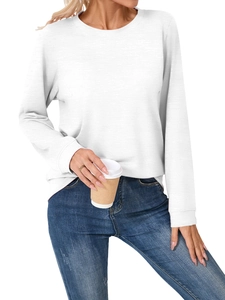 Detail of soft white long sleeve crewneck sweatshirt paired with classic blue denim jeans