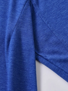 Detail of blue knit long sleeve tee showing stitching and premium fabric texture