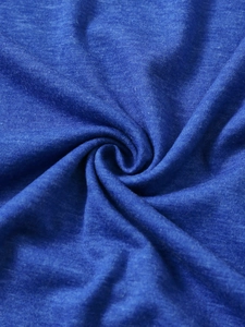 Detailed macro view of soft royal blue knitted fabric texture with fine mélange effect