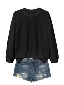 Flat lay of a long sleeve black crewneck t-shirt paired with distressed denim shorts