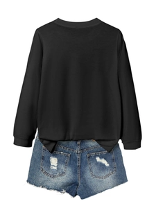 Back view of a long sleeve black sweatshirt paired with distressed denim shorts on white background