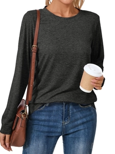 Detail of a dark grey long sleeve crew neck t-shirt with knit texture and brown leather bag