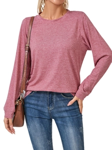 Close-up of pink heather knit long-sleeve tee paired with blue jeans and leather bag