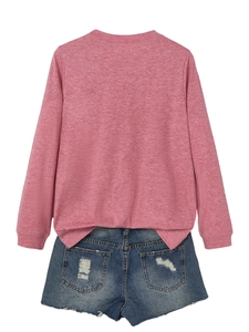 Flat lay of pink long sleeve knit shirt with distressed denim shorts on white background