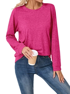 Detail of fuchsia long-sleeve knit top showing fabric texture and casual fit with jeans