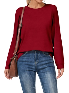 Detail of burgundy long sleeve top showing ribbed cuffs and soft knit fabric texture