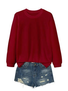 Detail of burgundy crewneck sweatshirt texture and distressed blue denim shorts
