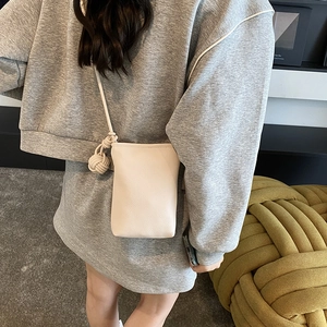 Minimalist cream mini crossbody phone bag with textured leather and knot detail
