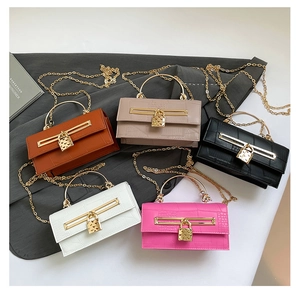 Close-up of crocodile pattern handbags in five colors with golden heart-shaped locks