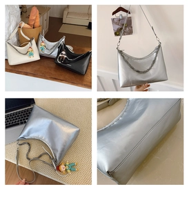 Detail of soft leather shoulder bag with metallic finish, chic chain, and cute doll charm