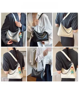 Multiple views of women's tote bag showing chain detail and colorful clown charm accessory