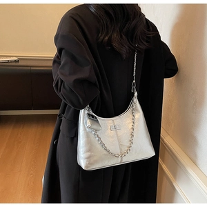 Close-up of metallic silver hobo bag with pleated texture and thick chain detail