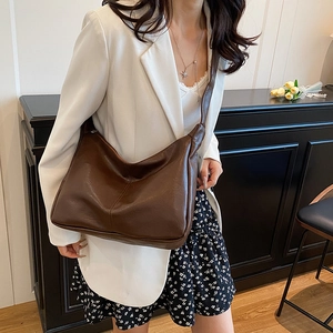 Minimalist large brown leather tote bag with soft texture for women commuting daily