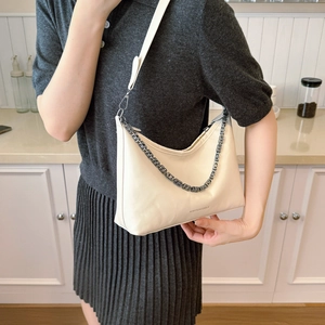 Minimalist beige soft hobo bag with silver chain strap and long leather shoulder strap