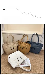 Detail of four colorful nylon tote bags with dual front zippers and side fashion labels