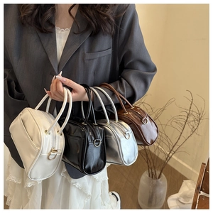 Collection of four stylish Boston pillow bags in white, black, silver, and brown colors