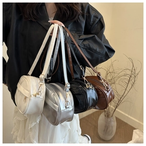Collection of minimalist oval crossbody bags in four colors with glossy finish