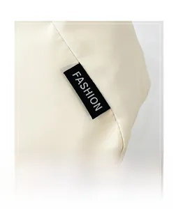Macro shot of minimalist canvas tote bag fabric texture and black Fashion woven label