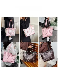 Detailed views of canvas tote bags with cherry and strawberry prints worn by a model