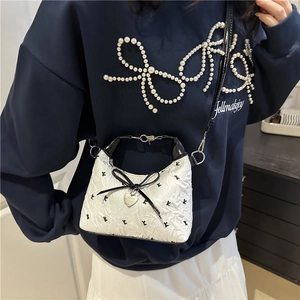 Chic floral fabric crossbody bag for women with black bow and heart pendant detail