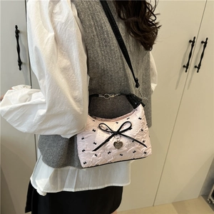 Pink floral jacquard shoulder bag with black bow and silver heart charm pendant