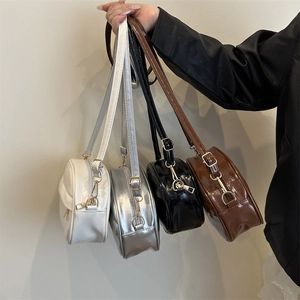 Minimalist round faux leather crossbody bags with adjustable straps in four shiny colors