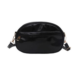 Glossy black shell-shaped crossbody bag with gold zippers and adjustable strap for women
