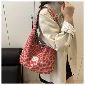 Detailed view of pink leopard print canvas tote bag with contrast lining and brand label